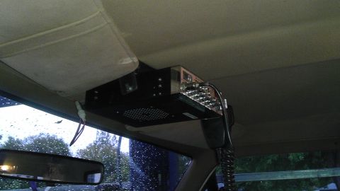 1989 Ford Bronco - A CB radio is mounted overhead in the vehicle, with a microphone hanging down.