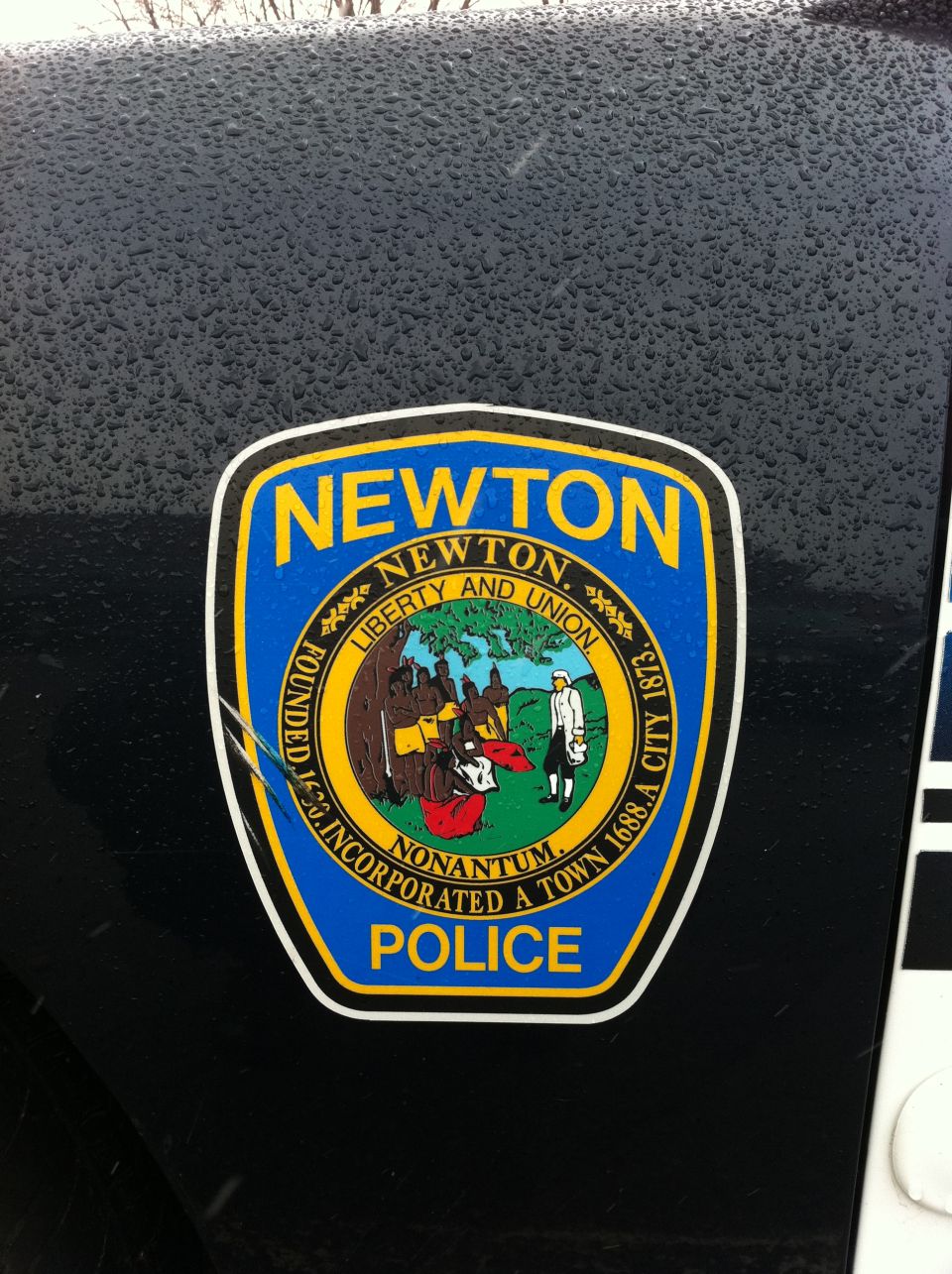 Black vehicle exterior with a Newton Police sticker on the side