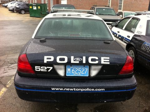 1991 Ford LTD Crown Victoria - A police car with "POLICE" and unit number 527 is parked next to another police vehicle.