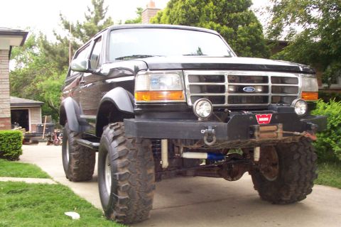 1995 Ford Bronco - This lifted 1995 Ford Bronco features large off-road tires and an aftermarket bumper with a winch.