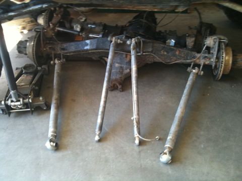 1966 Ford Bronco - Close-up view of vehicle suspension components, likely undergoing maintenance or repair.