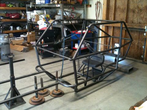 1966 Ford Bronco - A custom-built roll cage frame sits in a garage, awaiting further assembly.