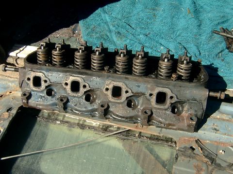 1982 Ford Bronco - Close-up of an engine cylinder head, showing its internal components and bolted connections.