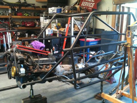 1966 Ford Bronco - This custom tube chassis is being worked on in a garage, with an engine and transmission installed.
