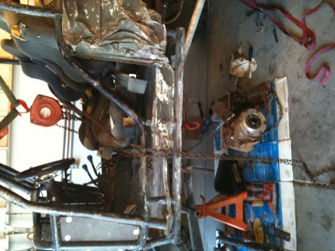 1966 Ford Bronco - Vehicle frame and components are heavily rusted and appear to be undergoing repair or disassembly.