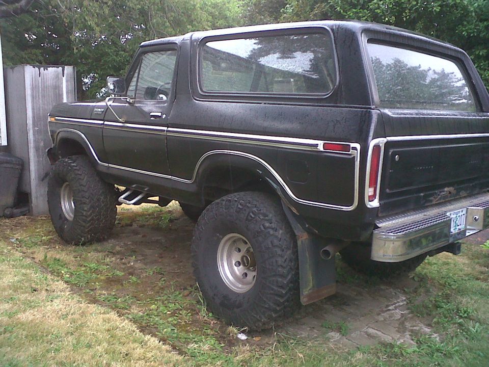 1979 Ford Bronco with lifted suspension and large tires, parked outdoors