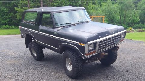 1979 Ford Bronco - This 1979 Ford Bronco features a lifted suspension and a distinctive chrome grille, presented in a three-quarter front view.