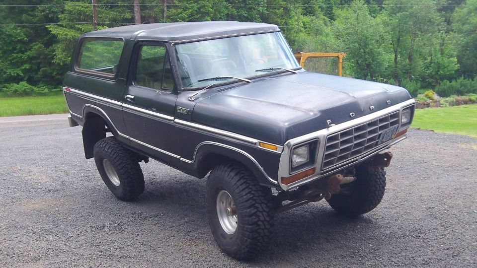 Dark blue 1979 Ford Bronco with lifted suspension and chrome grille