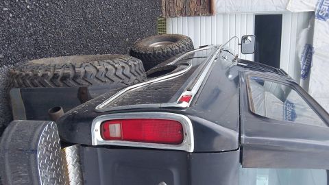 1979 Ford Bronco - Rear view of a 1978 Ford Bronco, with spare tires stacked behind it.