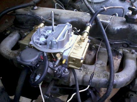 1981 Ford Bronco - Engine bay detail a carburetor and an intake manifold with visible "Offenhauser" branding.