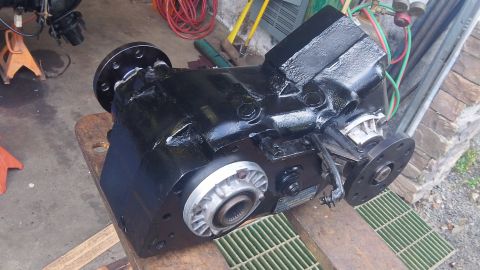 1979 Ford Bronco - A freshly painted transfer case sits on a workbench, ready for installation.