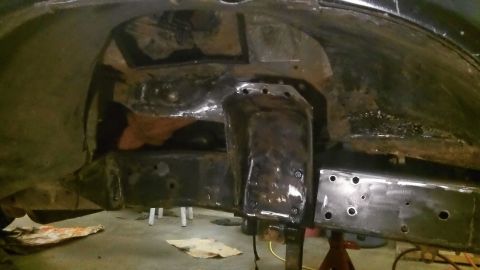 1979 Ford Bronco - Close-up view of modified vehicle frame and suspension components during a repair or modification process.