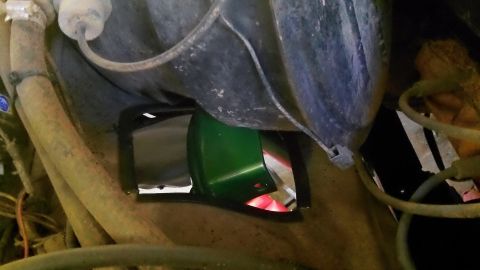 1979 Ford Bronco - Close-up of a green engine bay part, not a 1979 Ford Bronco.