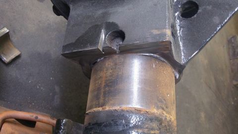 1979 Ford Bronco - A close-up view of a vehicle's suspension component, showing rust and welding marks.