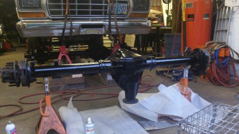 1979 Ford Bronco - Front clip of a 1979 Ford truck and its differential are being worked on in a garage.