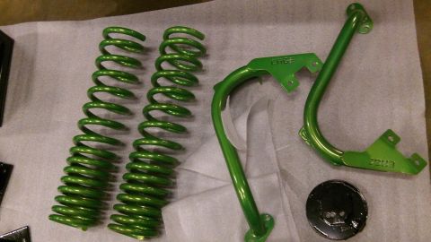 1979 Ford Bronco - Green painted suspension springs and metal brackets are laid out on a surface. Text visible on the parts includes "EDGE" and "2003".