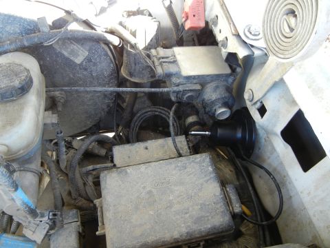 1996 Ford Bronco - This image shows various engine bay components, including a Ford-branded fuse box and brake booster assembly.