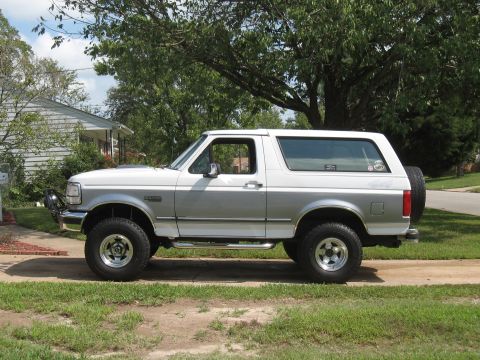 1994 Ford Bronco - This 1994 Ford Bronco is shown in a two-tone white and silver paint scheme with a spare tire mounted on the rear door.