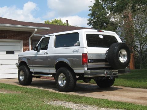 1994 Ford Bronco - 1994 Ford Bronco with two-tone paint and spare tire on the back.