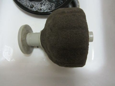 1968 Ford Mustang - A close-up view of a car's air filter, possibly being cleaned in a sink.