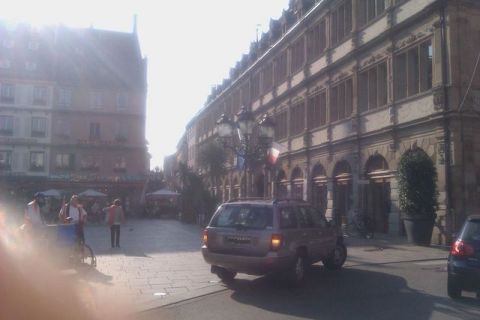 1991 Ford LTD Crown Victoria - A silver SUV is parked on a cobblestone street, with people and buildings in the background.