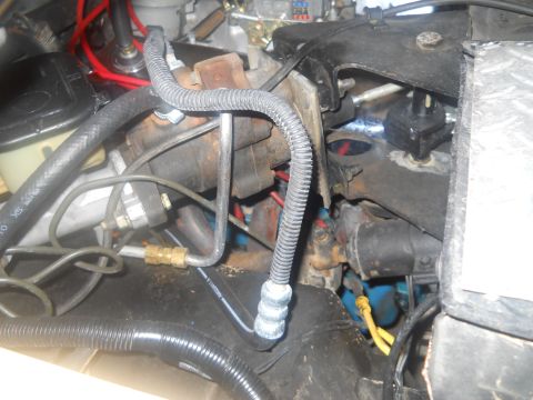 1976 Ford Bronco - Close-up view of engine bay components, including brake lines and hoses.