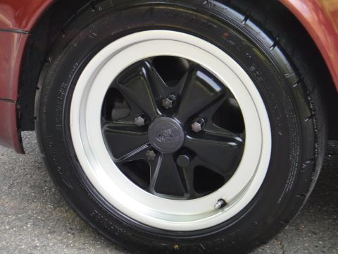 1986 Porsche 911 - A close-up view of a car's wheel, showing the tire and rim details.
