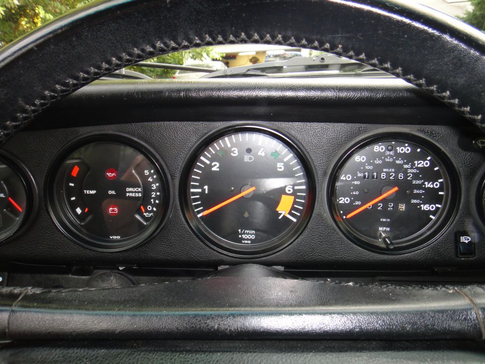 1986 Porsche 911 interior showing tachometer, speedometer, and oil pressure/temp gauges