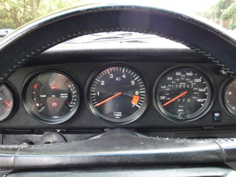1986 Porsche 911 - The interior view shows the car's dashboard gauges, including the speedometer and tachometer.
