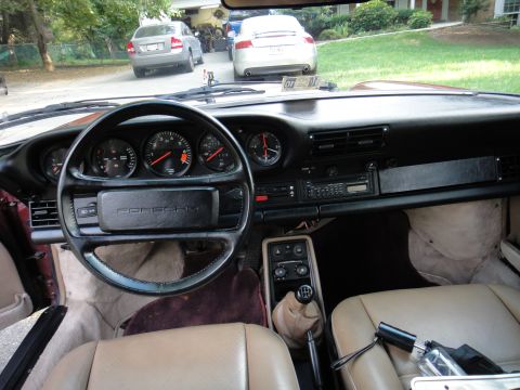 1986 Porsche 911 - Interior view of a 1986 Porsche 911, showing the dashboard, steering wheel, and tan seats.