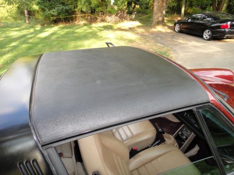 1986 Porsche 911 - Interior view of a 1986 Porsche 911 Targa, showing tan seats and the black roof panel. Another car is visible in the background.