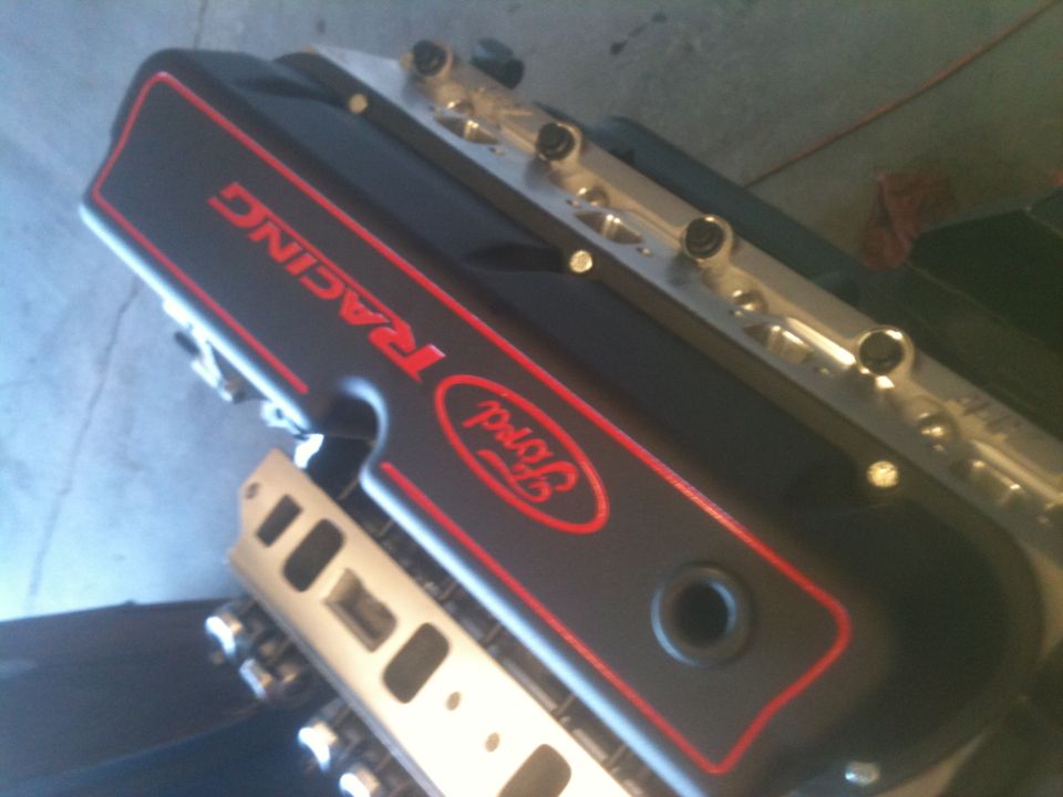 Black Ford Racing valve cover with red lettering