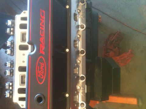 1993 Ford Bronco - Close-up of a Ford Racing valve cover and intake manifold part.