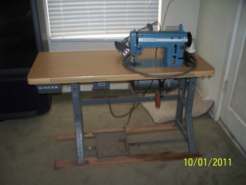 1990 Ford Bronco - Singer sewing machine on a table with a metal frame and foot pedal.