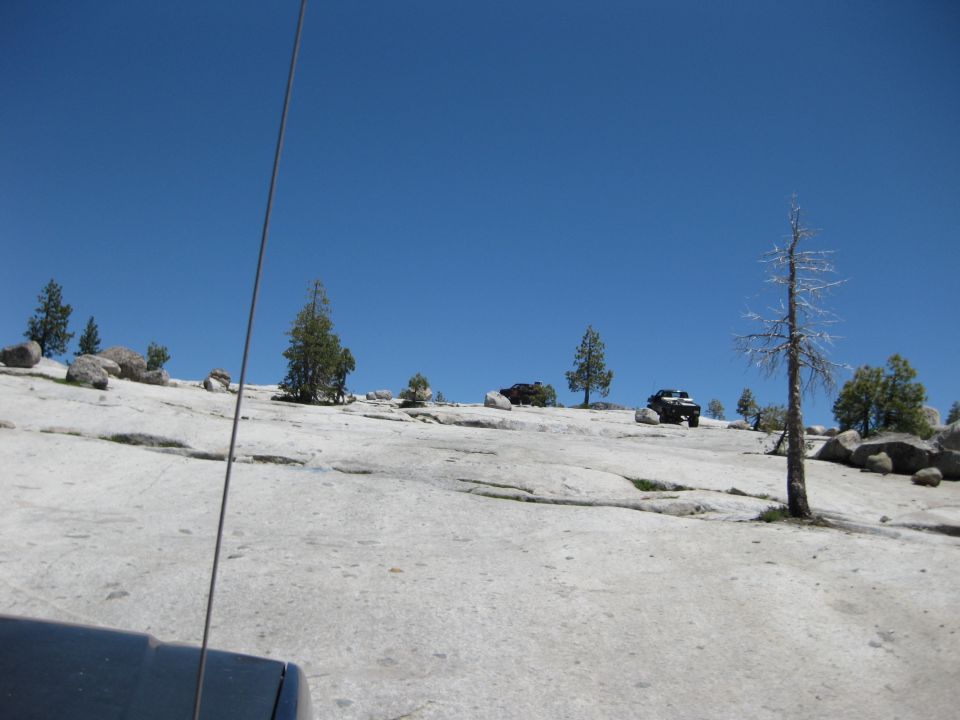 Two off-road vehicles on a rocky slope, one in the foreground, one further back