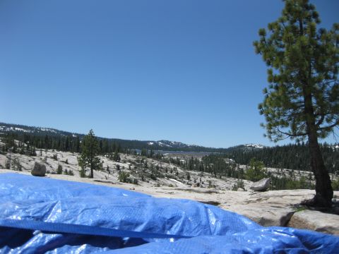 1971 Ford Bronco - A blue tarp is in the foreground of a scenic view with mountains and trees under a clear blue sky.