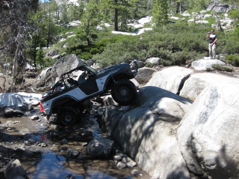 1971 Ford Bronco - A 1971 Ford Bronco navigates a rocky stream during an off-road excursion.