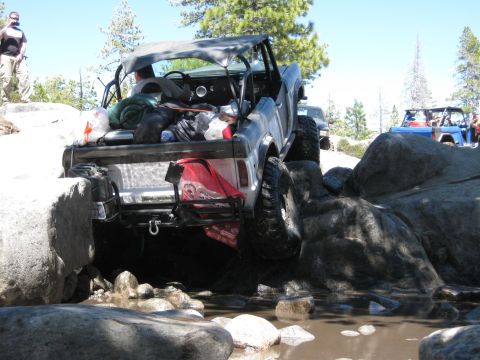 1971 Ford Bronco - This vehicle is loaded with gear and is carefully maneuvering over a rocky obstacle course.