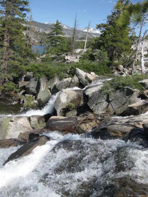 1971 Ford Bronco - A scenic view of a mountain lake and a rocky stream flowing through trees.