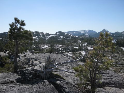1971 Ford Bronco - A vast mountain landscape with rocky outcrops, sparse vegetation, and distant snow-covered peaks.