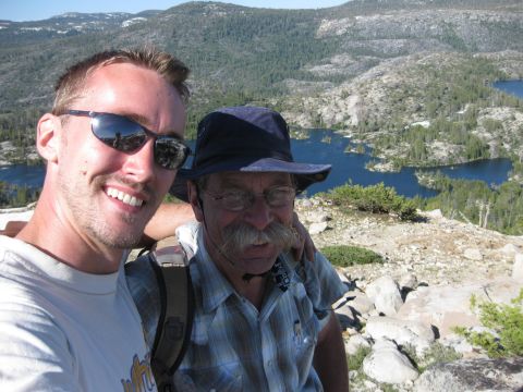 1971 Ford Bronco - Two men capture a selfie against a backdrop of mountains and lakes.