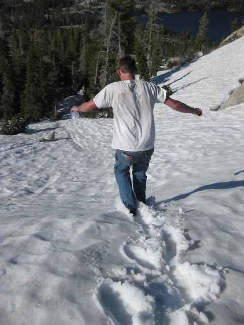 1971 Ford Bronco - A person walks through fresh snow with a body of water visible in the distance.