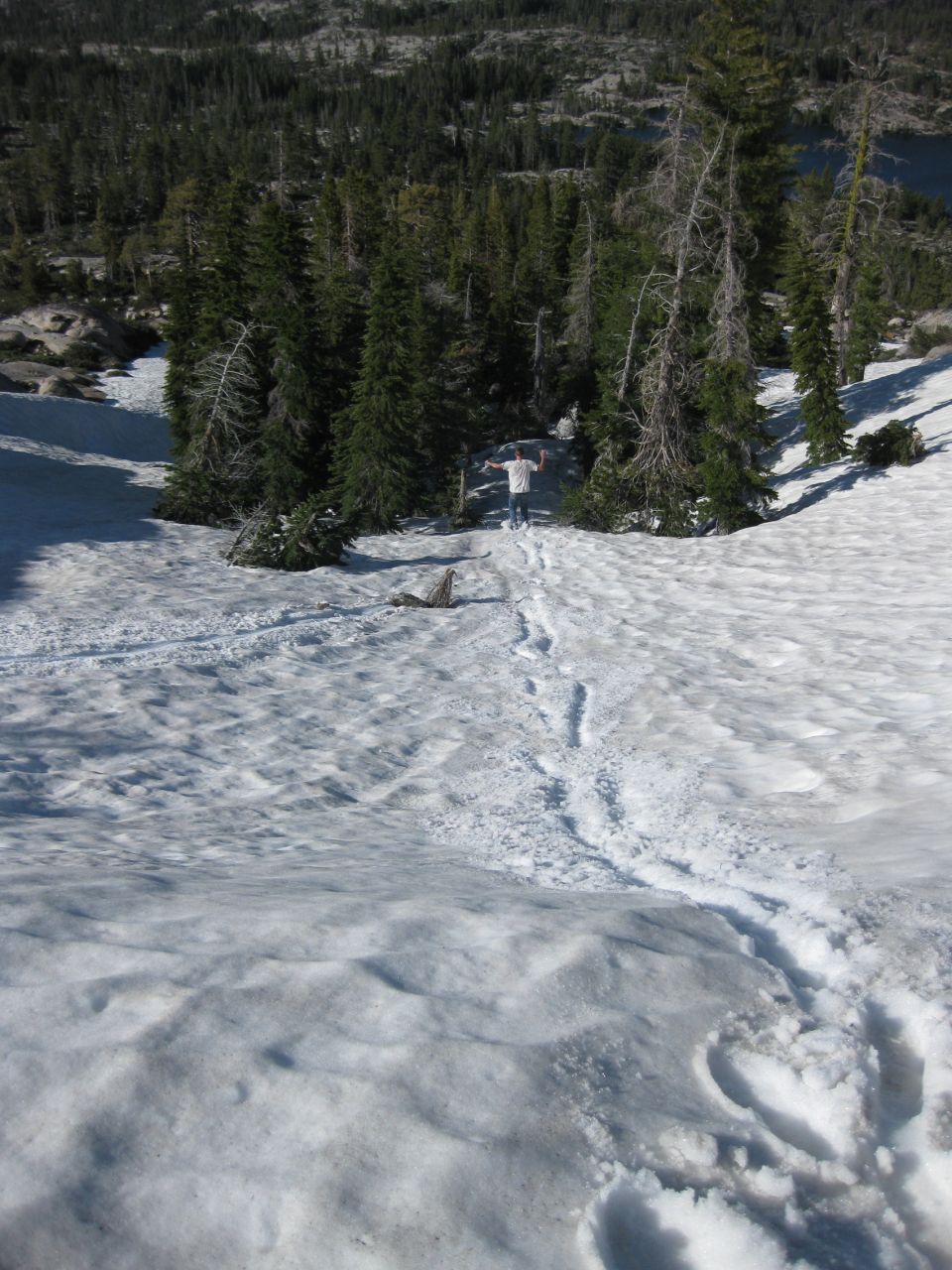 Person in snow with arms outstretched, Supermotors.net watermark