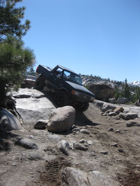 1971 Ford Bronco - Pickup truck tackling a challenging rocky trail with another vehicle in the background.