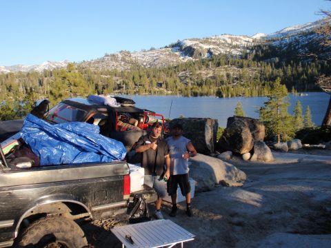 1971 Ford Bronco - Two men and a pickup truck are parked by a lake with mountains in the distance.