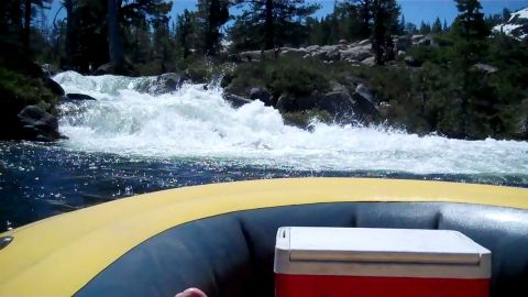 1971 Ford Bronco - Navigating whitewater rapids in a raft with a cooler onboard.