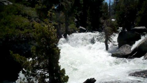1971 Ford Bronco - A turbulent river flows through a rocky, forested landscape.