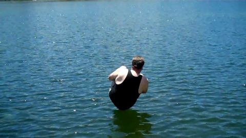 1971 Ford Bronco - A person sits in the water on a sunny day.