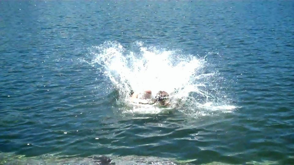 Person splashing into blue water