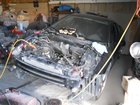 2006 Ford E350 - Car in garage undergoing repairs, front end disassembled.